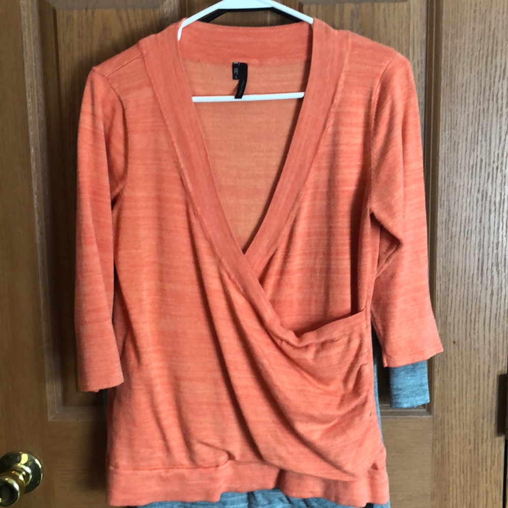 Light weight rouged wrap front sweater.